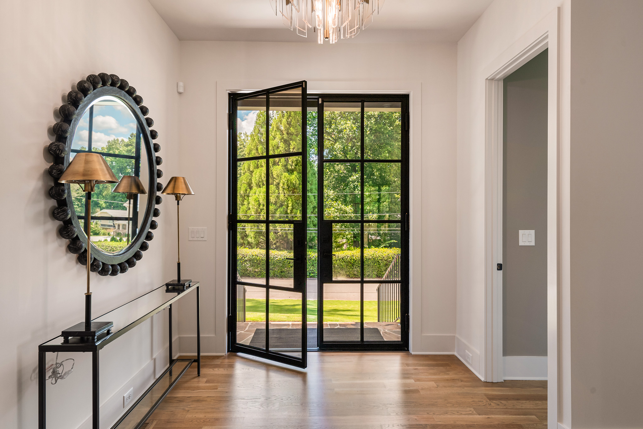 an open steel front door in a luxury room with natural light.