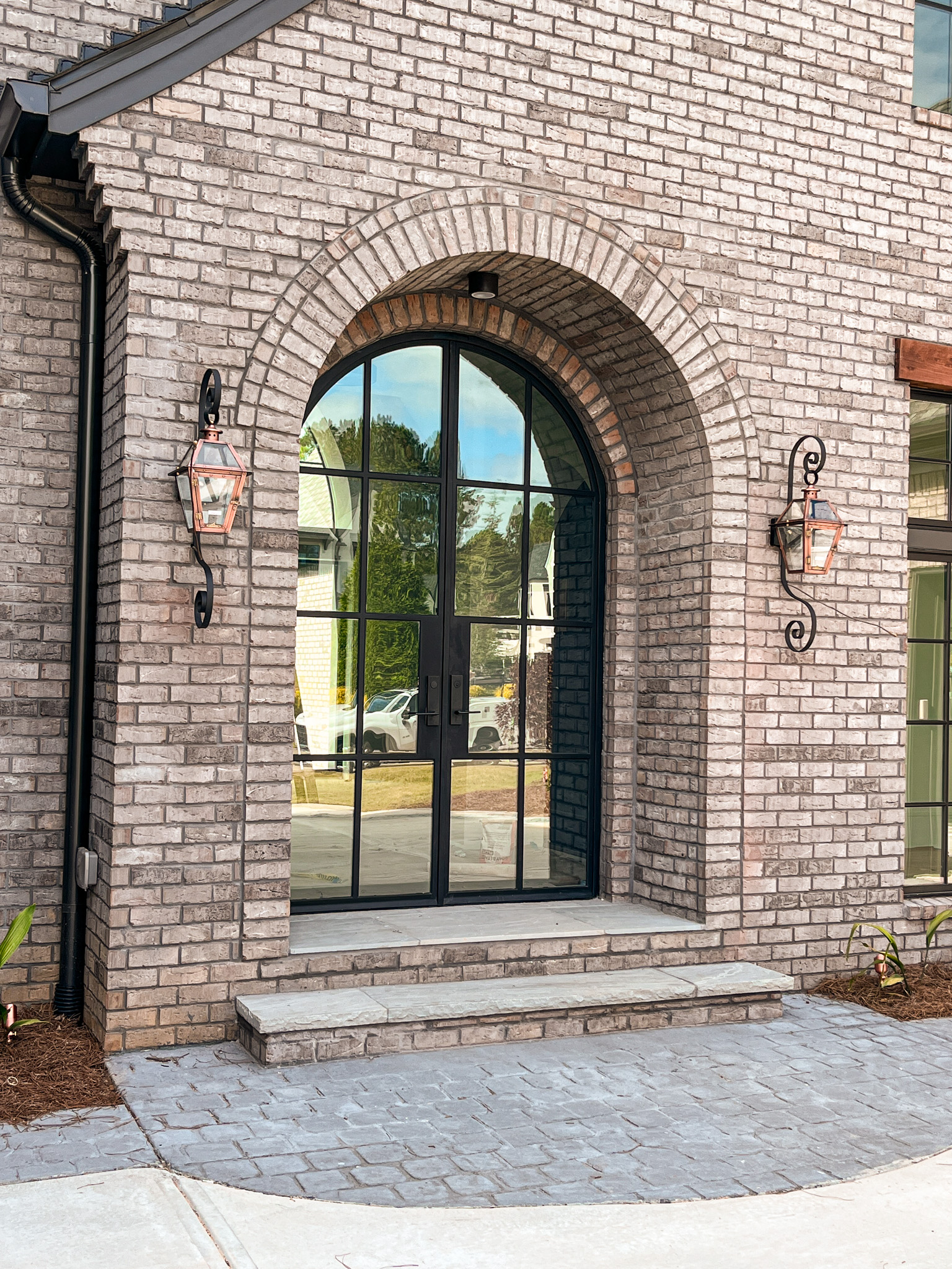 a brick building with a glass steel door