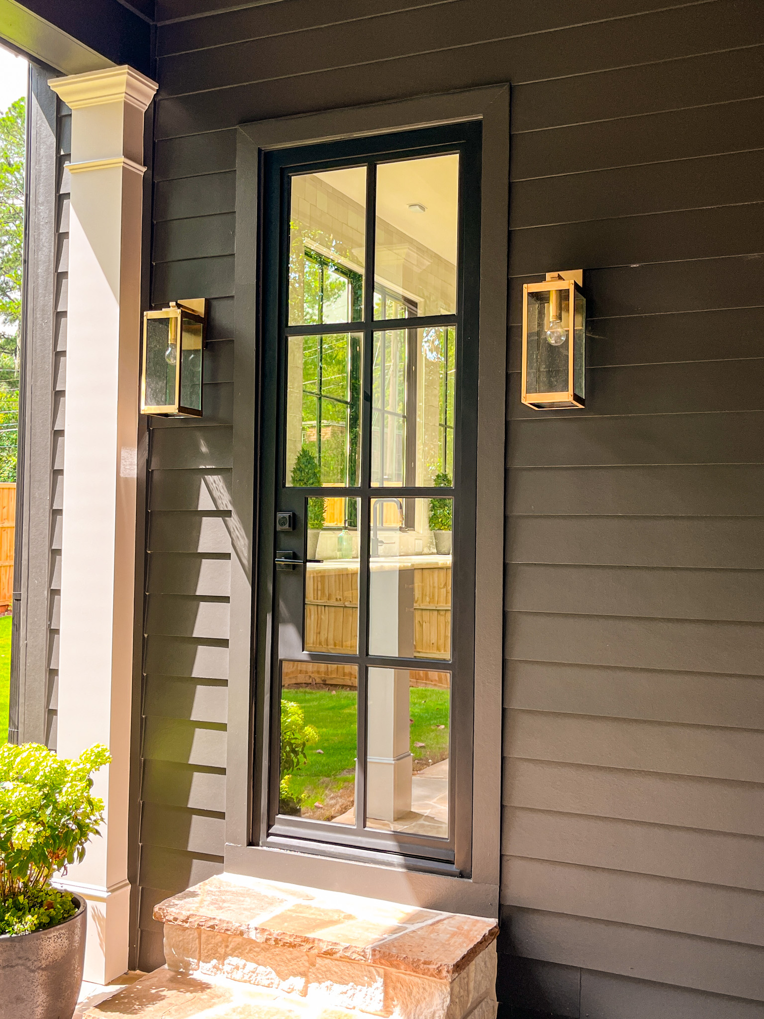 a steel door with a mirror on the front of a house